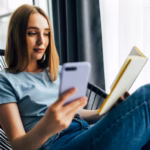 young-pretty-woman-reading-book-sitting-comfortable-chair-home_231208-12013
